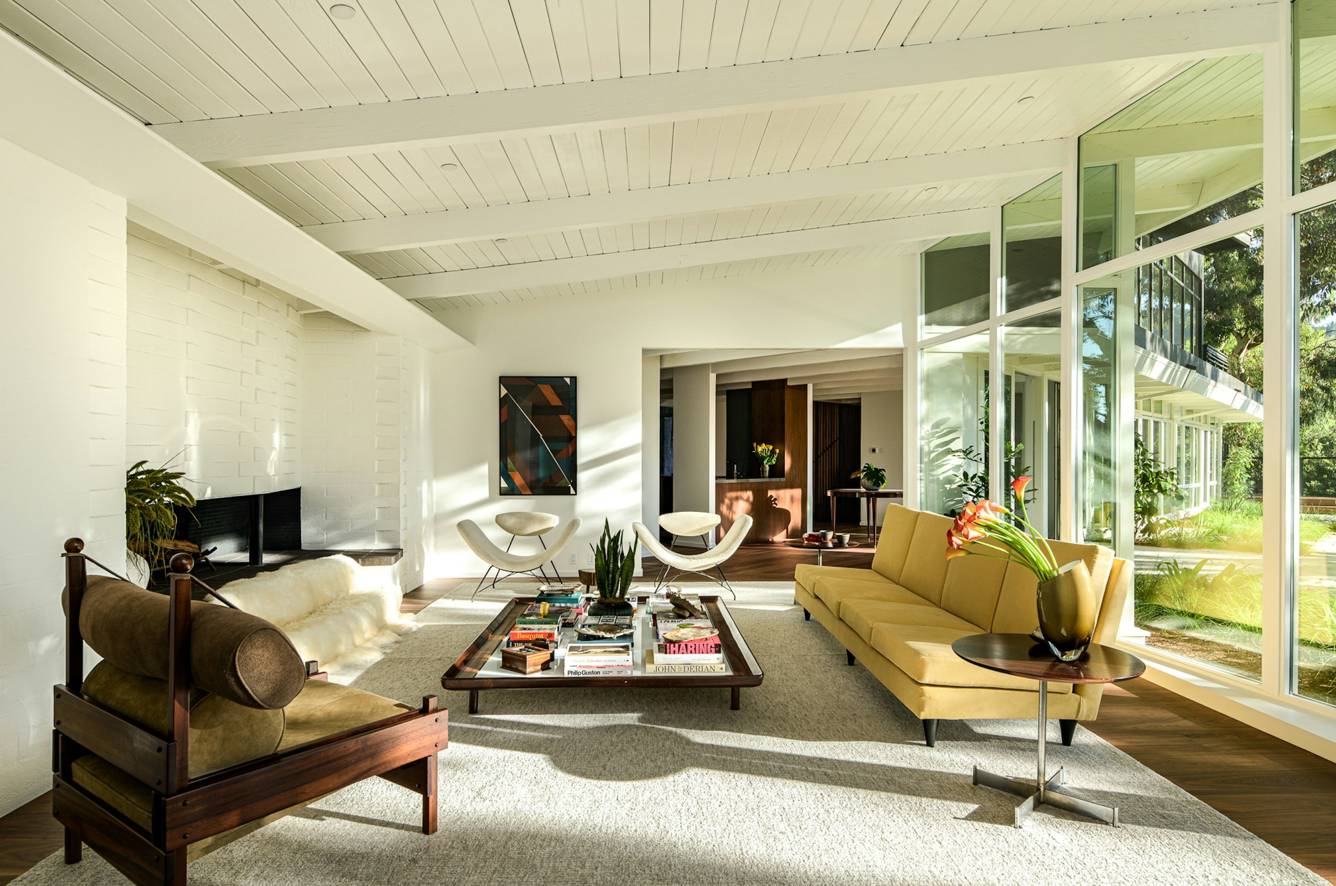 Mandeville Canyon midcentury living room with wood ceiling and glass walls to the garden